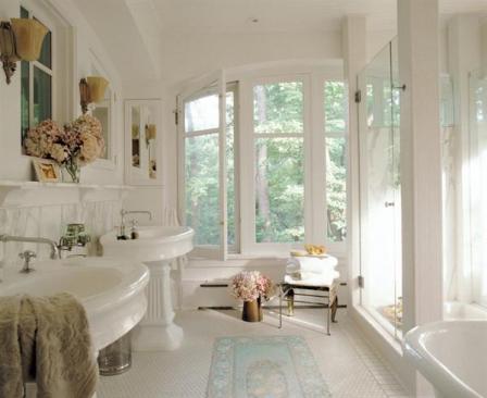 The sleek shower is the most mod fi xture in the bath. Crisp square columns support frameless glass walls that counter the rounded forms of period sinks and tub. The architects scoured Chicagos antique shops for authentic fi ttings to match the owners collection, yet their simple layout of freestanding pieces speaks to contemporary living.