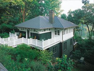 The home's low roofline keeps the surrounding community's water views intact. A wraparound front porch provides a place to chat with neighbors, while the decks on the rear of the building serve as more private outdoor rooms.