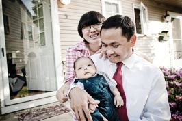 FINALLY ARRIVED: Cambodian-American Tooch Van, wife Chorvy, and son Winston, outside the Lowell, Mass., home they bought with help from a local housing group.