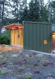 The budget-conscious building is constructed of polycarbonate, wood framing, and metal cladding and is topped with a homemade green roof of drought-tolerant succulents.