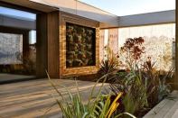LISI, by Team Austria, features a living wall in both of its exterior courtyards, which are surrounded by fabric curtains that cast dappled shadows across the outdoor living spaces.