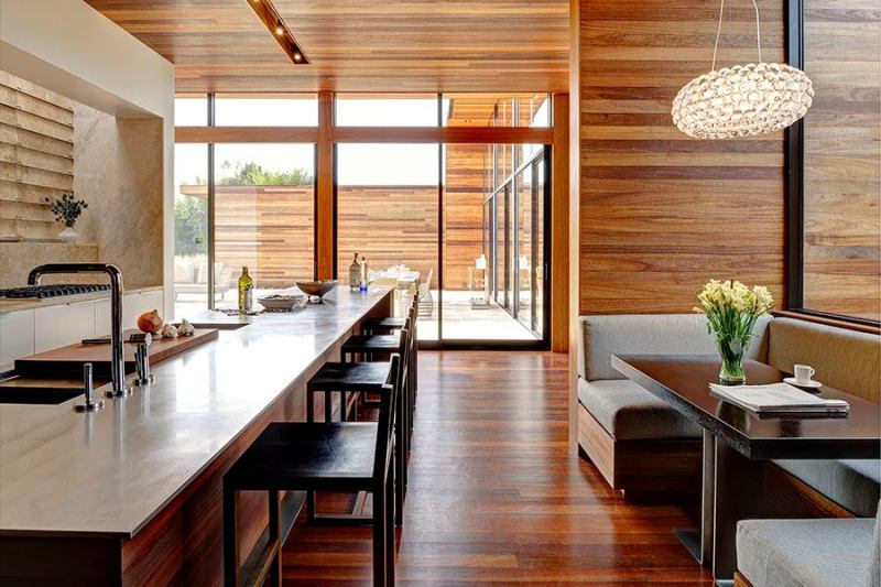 Mahogany siding wraps around the house and continues to the interior, reinforcing an inside-outside connection.