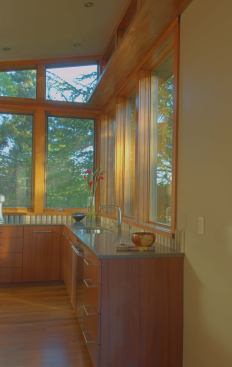 A detail shot of the kitchen, with wood cabinets and quartz countertops.