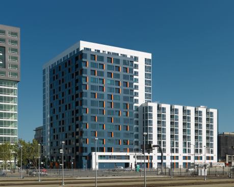 In pricy San Francisco, this development aims at providing modestly priced condos to first-time buyers. To add a sense of vibrancy to the neighborhood, located in a still-developing part of the city, the developer opted for bright blue cladding with orange accents. Architect: Kwan Henmi Architecture/Planning, San Francisco Builder: Bovis Lend Lease, San Francisco