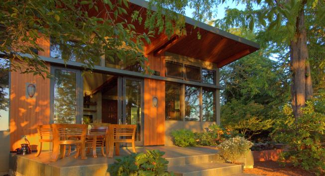 Measuring 2,300 square feet, the home features wood cladding and large window and doors that results in lots of natural light.