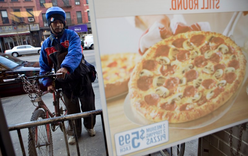 Hossain Md prepares to make a delivery from a Domino's Pizza franchise on 89th Street in New York, U.S., on Wednesday, Jan. 13, 2010. Domino's Pizza Inc., the second-largest U.S. pizza maker, said Internet orders make up the fastest-growing part of its business, accounting for as much as 30 percent of sales in some markets. Photographer: Daniel Acker/Bloomberg via Getty Images