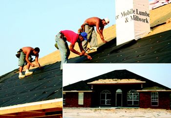 A crew papers the roof of a new home under construction near Gulfport, Miss.