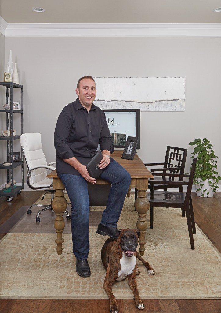 Nick Molfino and his dog, Tyger, in the office of his Ashburn, Va., home, just outside of Washington, D.C.
