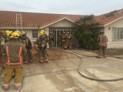The Clark County Fire Department's live fire training exercise in progress at one of the abandoned homes provided by American West Development.