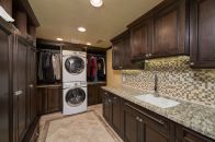 Hochuli Design & Remodeling Team used popular materials like stone flooring, custom cabinetry, and glass mosaic tile for this revitalized space.