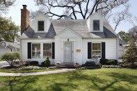 White home in suburbs with brick sidewalk