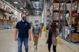 Parker Shoaf and Phabian Mascorro, Hakes Brothers' San Antonio sales agents, tour the San Antonio Food Bank with Philanthropy Manager Aniza Lopez.