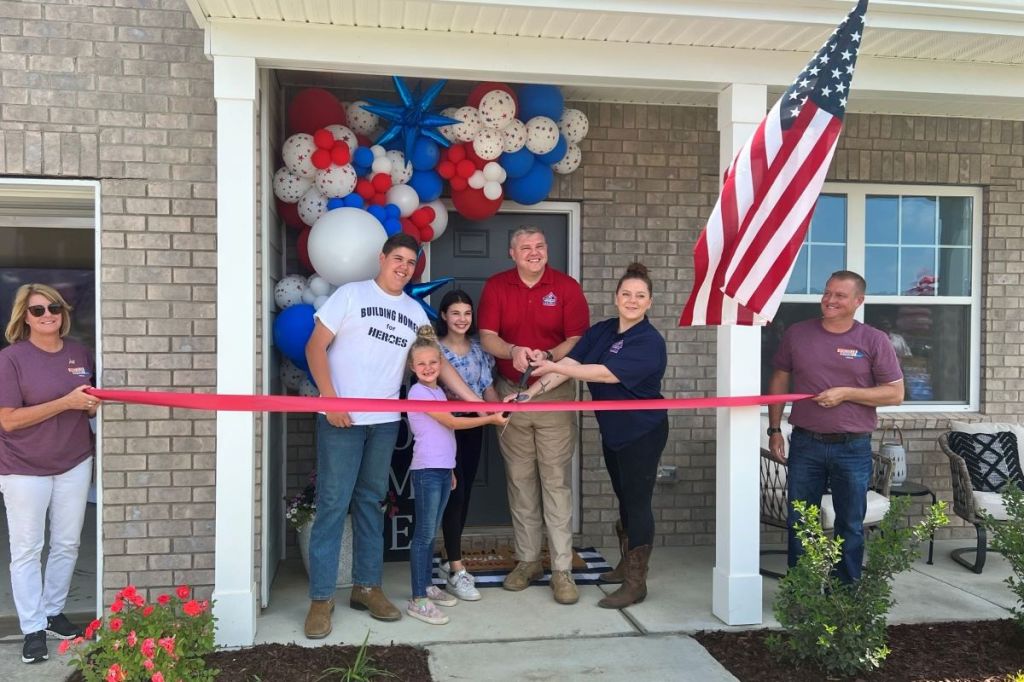 Army Spc. Christopher Lewis with his family in Murfreesboro, Tennessee, cutting the ribbon on his mortgage-free home through Building Homes for Heroes and PulteGroup.