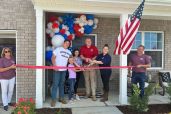 Army Spc. Christopher Lewis with his family in Murfreesboro, Tennessee, cutting the ribbon on his mortgage-free home through Building Homes for Heroes and PulteGroup.