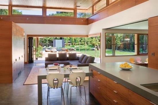 Accordion doors link the kitchen to the backyard and pool area
