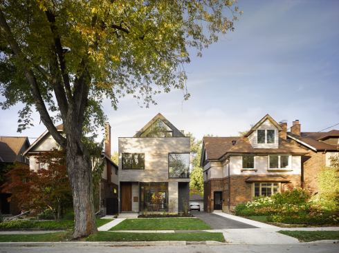 Careful control of massing and setbacks—along with a set-back gable roof—harmonizes the new building with its 1920s-era neighbors.