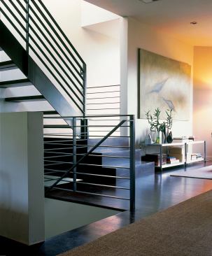 The open staircase has a sculptural feel, and it reinforces the feeling of lightness in this formerly dark cottage. Making the house deeper front to back would have made the interior darker, says Bernstein.