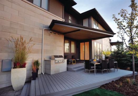 This alley-loaded lot squeezes in an outdoor space on the side of the home complete with the outdoor kitchen essentials. There's a built-in grill on the side fa&ccedil;ade and a roof and porch that echo the home's unusual angles. The porch was built with wood from trees killed in Colorado's pine beetle plague. 
Project: Lime Model at Stapleton, Denver; Architect: Woodley Architectural Group, Littleton, Colo.; Builder: Infinity Home Collection, Denver