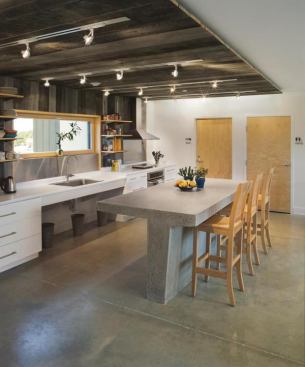 Barn boards add texture to the ceiling of this student dorm, helping define the kitchen in the open gathering space.   
Project: Terra Haus, Unity, Maine; 
Builder and Architect: GO LOGIC, Belfast, Maine