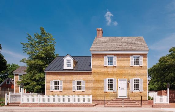 The historical two-story house remains prominent from the street.