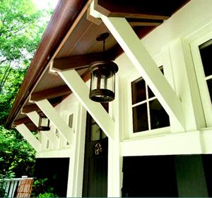 Horizontal tongue-and-groove interior paneling and a contrasting rafter tail-and-outlooker detail contribute to the project's handcrafted feel.