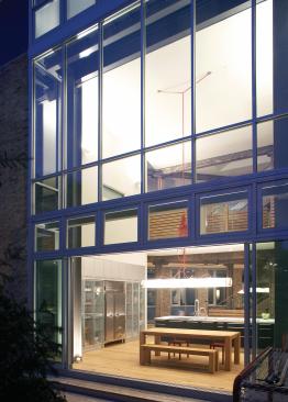 Using off-the-shelf industrial products, such as aluminum windows for the wall of glass that connects the kitchen to the outdoor deck, set off this building�s good looks. Using ready-mades instead of custom materials also helped saved on budget.