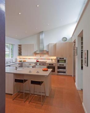 Hacienda's efficient kitchen opens on to the dining/living areas, splashed with daylight from clerestory windows. Water-efficient fixtures, LED lighting, and Energy Star-rated appliances top off the performance features, while cork flooring and Ceasarstone tops add to the resource efficiency of the home.