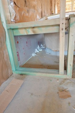 Code requires air-sealing the area behind the tub, as shown here.