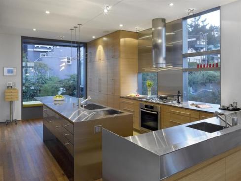 Wood cabinets work together with steel drawers to provide warmth while maintaining a modernist feel in this contemporary family home. Project: Laidley Street Residence, San Francisco; Builder: Built Form Construction, San Francisco; Developer/Architect: Zack|de Vito Architecture, San Francisco