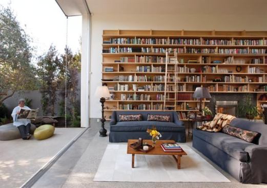 An operable glass wall provides an airy element to balance out the visual heft of a built-in wall of books. The project was a 2012 Custom Home Design Award winner. Project: Goodman Residence, Venice, Calif.; Builder: Oliver Construction Co., Thousand Oaks, Calif.; Architect: Abramson Teiger Architects, Culver City, Calif.