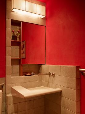 The tiny powder room in this San Francisco condo has fire-engine red walls and makes excellent use of corner space with a sink of Geocrete, one of the concrete blends that the designer is well-known for. Project: Zuckerman Residence, San Francisco, Calif.; Designer: Fu-Tung Cheng, Cheng Design, Berkeley, Calif.; Builder: Matt Blickman, 38 Degrees North Latitude Builders, San Rafael, Calif.