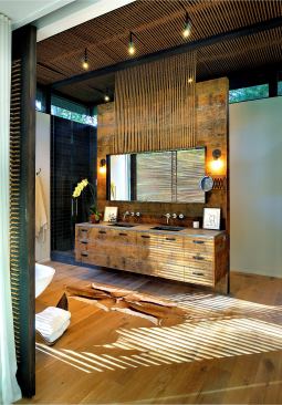 One of the most inspiring objects for the project was a rope chair by famed Danish furniture designer Hans Wegner. The rope lends a hand-crafted feel, while concealing the mechanicals, revealing the lighting, and suspending the vanity mirror. The rope is also used as a screen on the sliding glass doors next to the tub.
