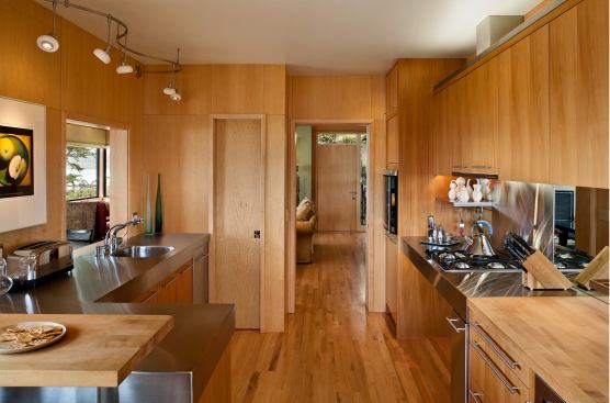 While this Carmel, Calif., kitchen by Carver + Schicketanz Architects and McNamee Construction isn't exactly a micro-loft, it's as snug as a ship. Stainless counters provide workspace in what's essentially a galley layout, with room for on-demand storage underneath. Behind the pocket door is a pantry. A pass-through to the dining room allows dinner to be served, and mirrors give the impression of expanded space. The kitchen won a 2012 Watermark Award.
