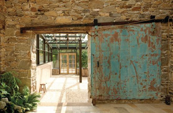 On Site July/August 2012 Rural Renewal Builder: Burdg, Dunham and Associates, Hamilton, Mo.; Architect: Meyer, Scherer & Rockcastle, Minneapolis The worn blue door, found in a local warehouse, marks a service entrance between the kitchen and orangery.