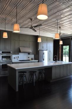 Hanging+from+the+restored+ceiling+are+off-the-shelf+floorlamps+that+were+re-rigged+as+pendants.+