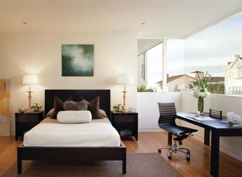 A folded street-front facade allows this guest room window to wrap a corner.
