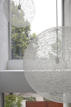 Charged with creating a clean, bright,  modern home in Chicago, the design team incorporated light fixtures that add texture without breaking  the home’s white palate or views of the outside.    
Project: Bucktown Three, Chicago, Ill.; 
Builder: Stedl Construction & Development, Chicago; 
Architect: Studio Dwell Architects, Chicago