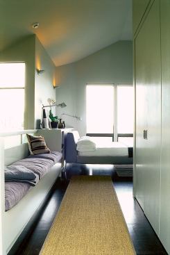 On the third floor, an extended hallway functions as a dressing area, with room for closets. The bench has a guardrail and storage underneath.