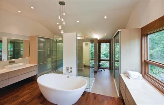 This bathroom’s design intentionally incorporated as many glassy surfaces as possible to reflect the windows’ forest views, surrounding the interior space with natural scenery. Project: Lyons Residence, Gladwyne, Pa.; Architect: Moto Designshop, Philadelphia; Builder: SJ Design Build, Wynnewood, Pa.