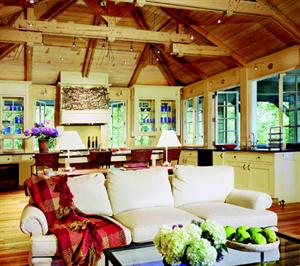 Delicate track lighting illuminates the rugged, timber-framed ceiling structure
