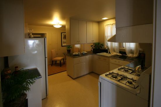 Before: Dated cabinets and appliances and cumbersome circulation kept the original kitchen stuck many decades in the past.