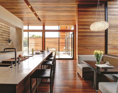 2013 Kitchen of the Year: Sam's Creek, Bidgehampton, N.Y. The island’s plate-steel countertop has a recessed drainboard that holds a removable cutting board. The custom pedestal table at the dining booth conceals power outlets for laptops and other personal electronic devices.