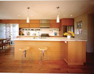 Windows back a glass-fronted cabinet, which transmits daylight while screening views of a neighboring house.