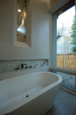 Expanding the views yet creating privacy from the street was key for this entire remodel, bathroom included. The house has a 5,000-gallon rainwater collection system and a five-star rating from the Austin Energy Green Building program. Architect: Rodney Palmer, Cornerstone Group Architects; Builder: Chris Shaffer, Greenbelt Homes