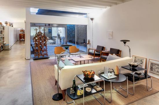 Interiors are divided by a secluded courtyard into two equal modules. The front module is living, dining, and the kitchen.