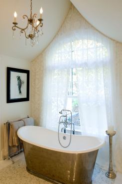 In a Maine seaside house built in the 1880’s that was once used as a Bed and Breakfast, a cast-iron and copper leaf tub maintains a Victorian feel. Architects: Anthony Barnes and William Wheeler, Barnes Vanze Architects; Builder: Mark Sweeney, Classical Endeavors