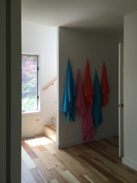 A cluster of hooks by the from door provide easy access to towels on the way down to the pool.