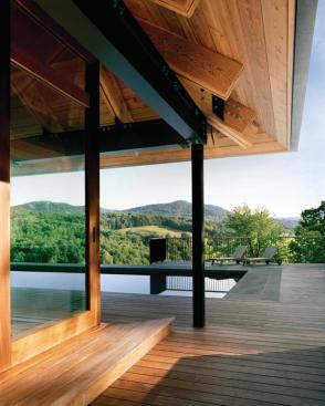 The pool house counterpoints the rugged, purposeful look of the compound with more refined bluestone floors and a copper roof. 