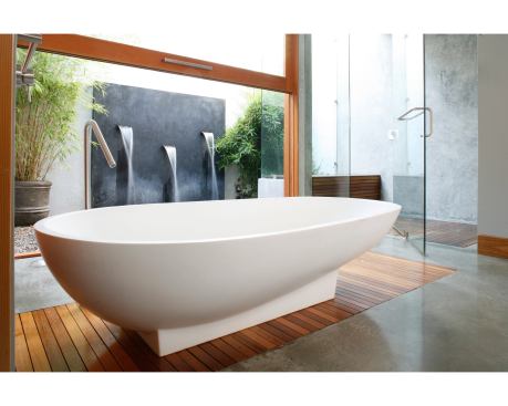 The sensual lines of this tub are right at home among the bathroom’s spa-style details and soothing surroundings, such as teak platform, heated floors, and visual quietude. Architects: Erla Ingjaldsdottir and Tryggvi Thorsteinsson, Minarc; Builder: Lannen Construction