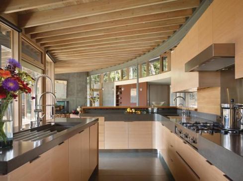 Matching Douglas fir doors, windows, millwork, and cabinetry give this home a cohesive aesthetic, while exposed beams provide texture and stave off monotony. Project: Suncrest, San Juan Island, Wash.; Builder: Ravenhill Construction, San Juan Island; Architect: Heliotrope Architects, Seattle